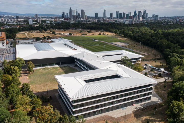 Aerial view of the new DFB campus with Frankfurt skyline in the background.