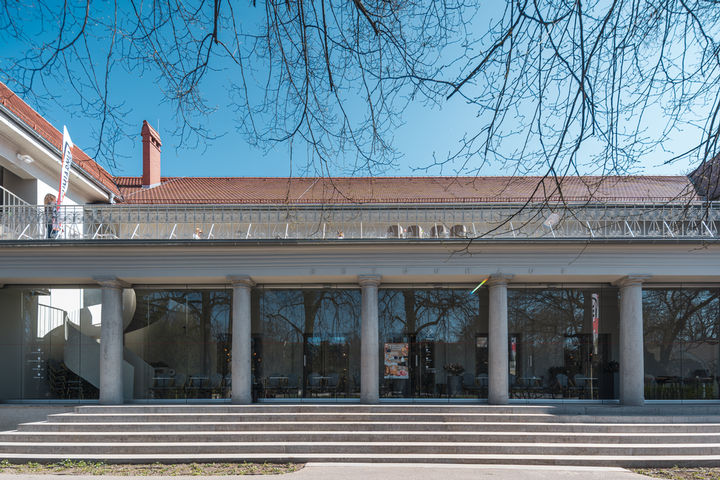 Front view of the historic Betonhaus Poznań with large entrance steps