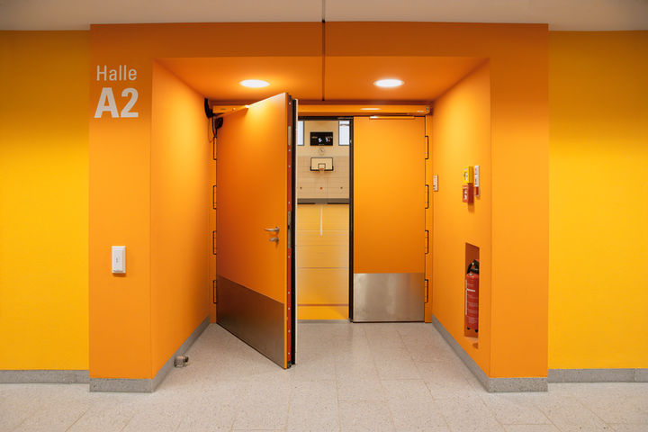 Orange entrance door to Gym A2 at Freiham Sports Park