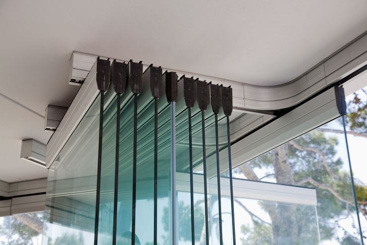 Sliding doors made of glass provide natural light in rooms.