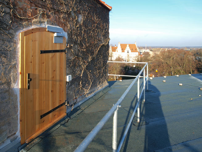 Outdoor shot of the roof exit door from the tower