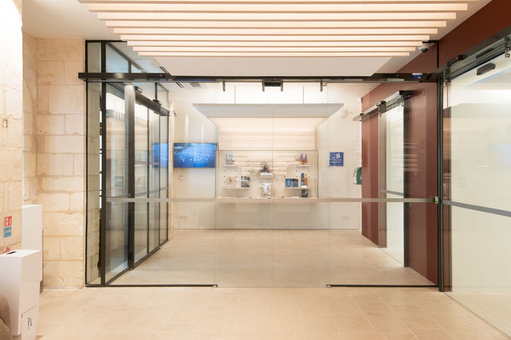 The reception desk is behind an automatic all-glass door that makes sure the entrance to this historic building is accessible to all.