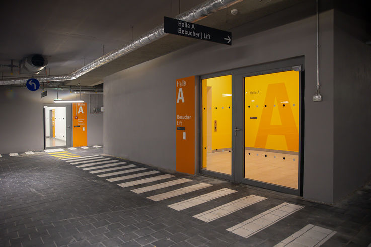 Night-time view of the underground car park with entrance door leading to the stairwell and lobby